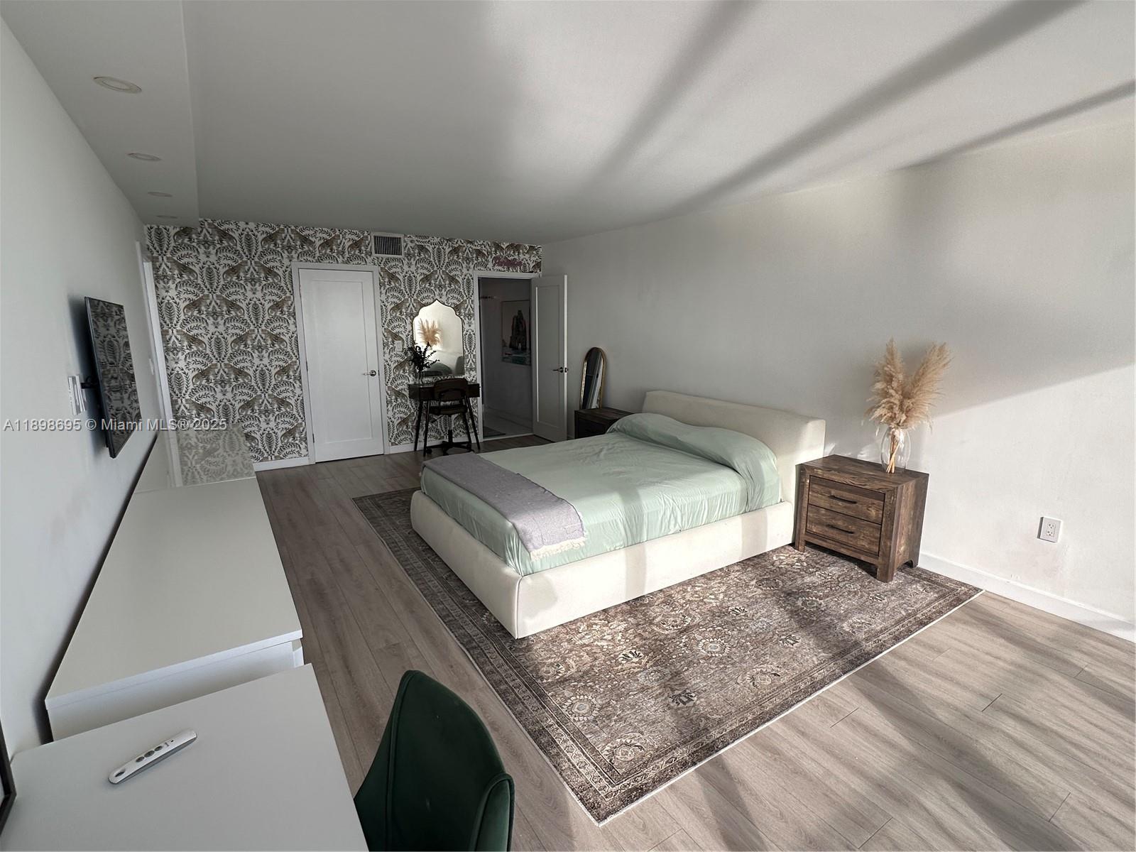 555 Northeast 15th Street, Unit 23B Miami, FL 33132 - Photo 13 of 32 a bedroom with a bed and window