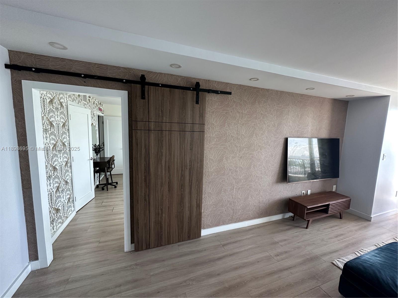 555 Northeast 15th Street, Unit 23B Miami, FL 33132 - Photo 20 of 32 a view of a livingroom with wooden floor and furniture