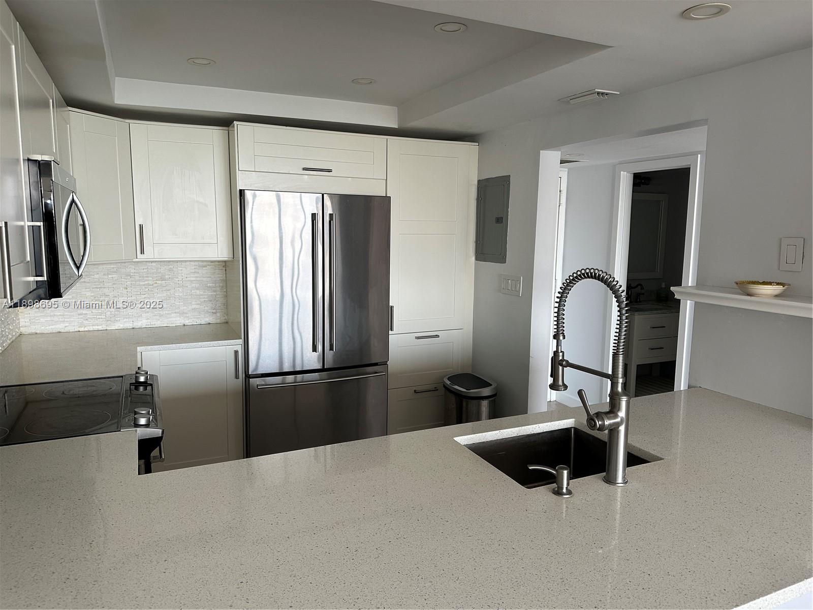 555 Northeast 15th Street, Unit 23B Miami, FL 33132 - Photo 21 of 32 a kitchen with a refrigerator and a sink