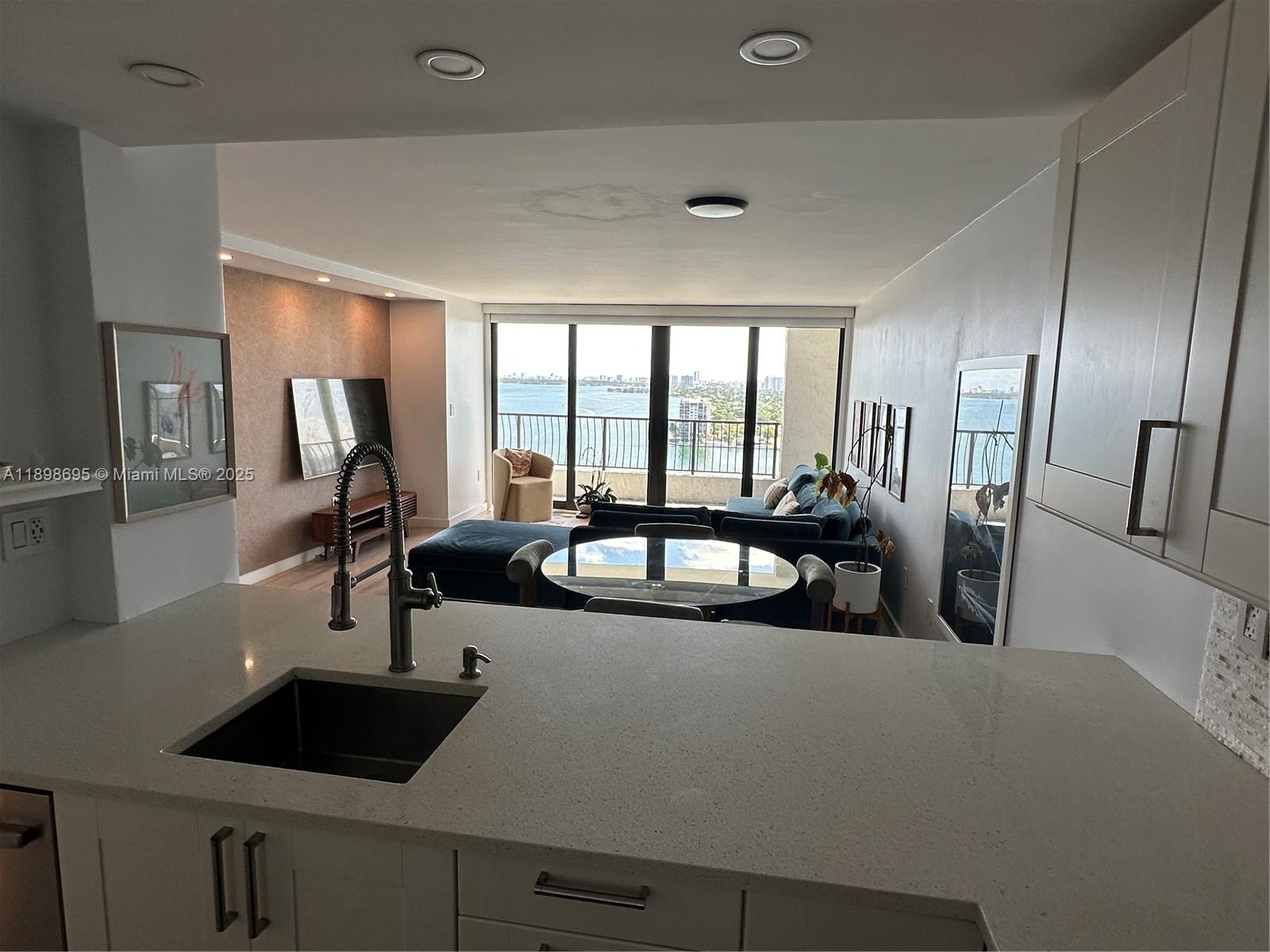 555 Northeast 15th Street, Unit 23B Miami, FL 33132 - Photo 5 of 32 a view of a sink and dishwasher with wooden floor
