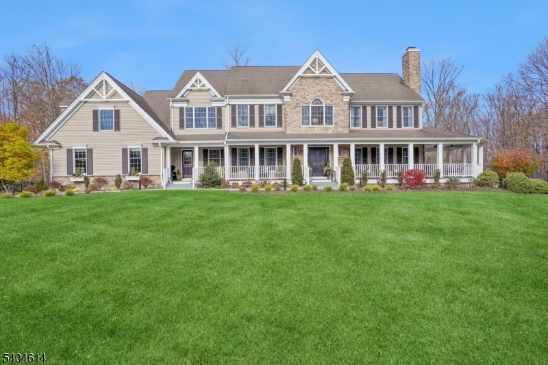 a front view of a house with a garden and trees