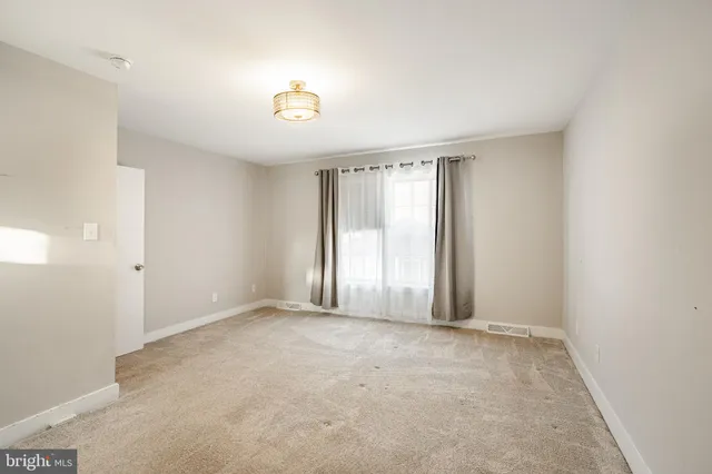 an empty room with windows and entrance