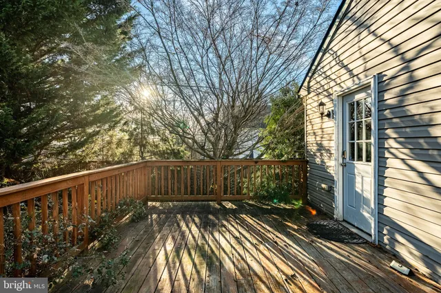 a view of backyard with deck and wooden floor
