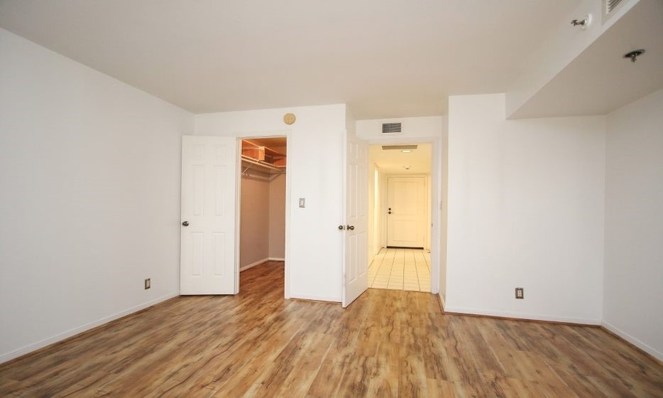 3525 Sage Road, Unit 318 Houston, TX 77056 - Photo 43 of 46 a view of an empty room with wooden floor and a bathroom