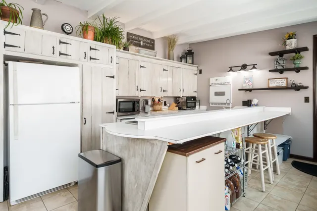 a kitchen with a sink cabinets and window