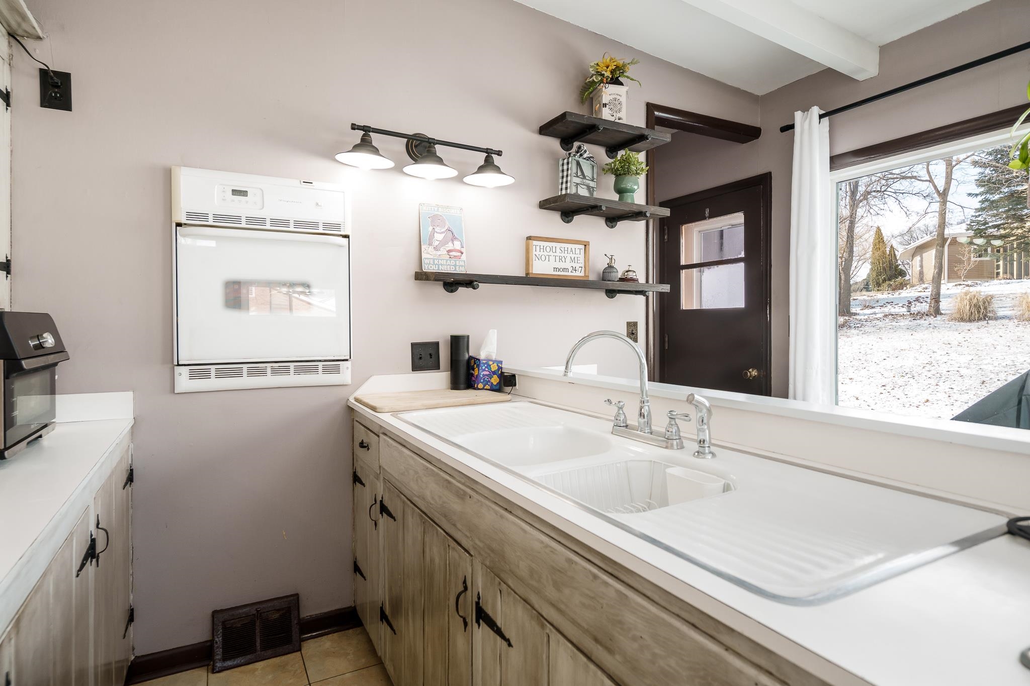 106 Mix Street Oregon, IL 61061 - Photo 25 of 49 a kitchen with a sink cabinets and window