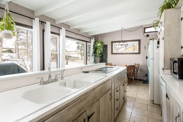 a view of a dining room with furniture and a potted plant