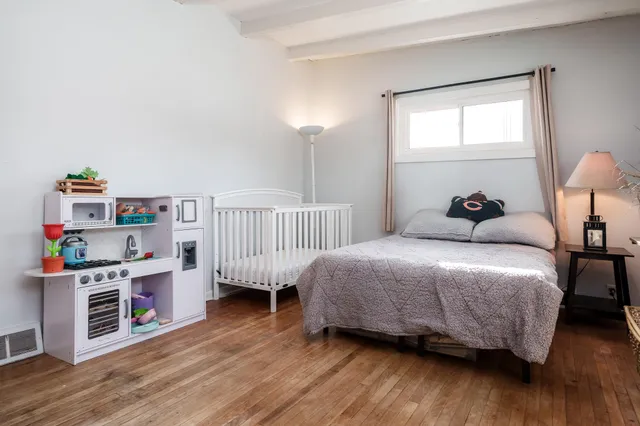 a bedroom with a bed and a large window