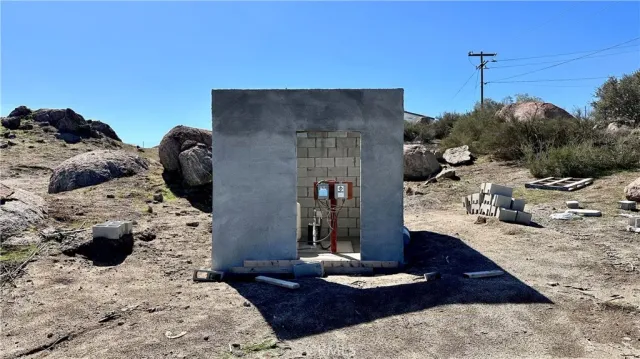 a room with water heater and wooden walls
