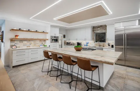 a kitchen with stainless steel appliances a sink a stove a refrigerator and cabinets