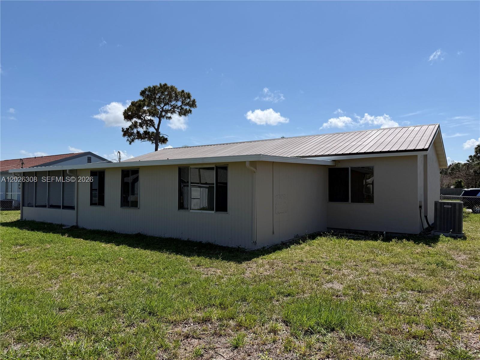 653 Atlas Avenue Northeast Palm Bay, FL 32905 - Photo 20 of 22 a front view of a house with a yard