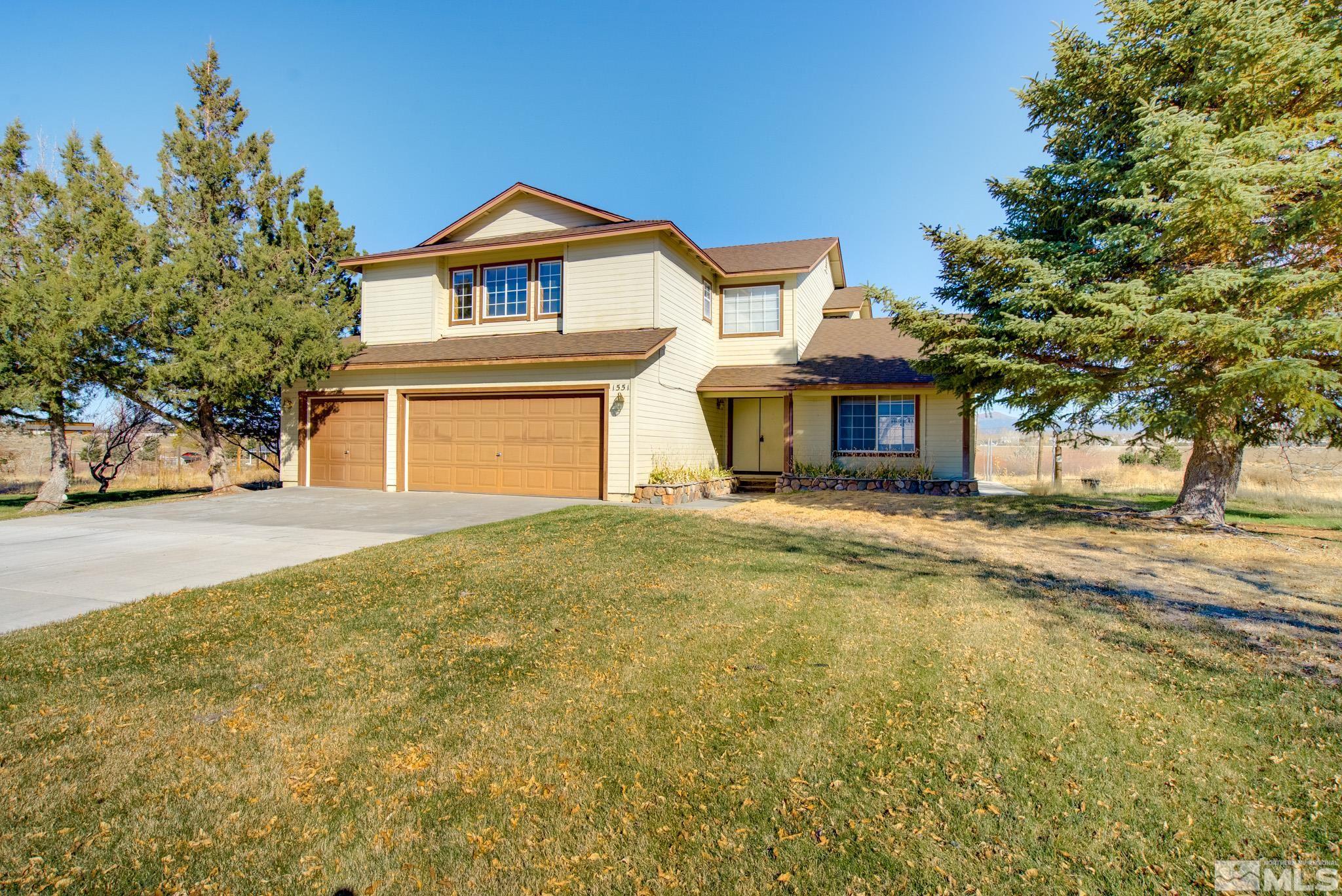 1551 Lombardy Road Gardnerville, NV 89410 - Photo 1 of 37 a front view of a house with a garden