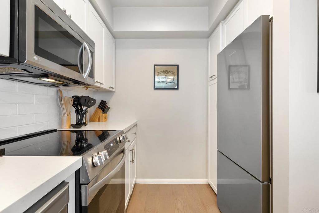 940 Sealane Drive, Unit 14 Encinitas, CA 92024 - Photo 11 of 45 a kitchen with stainless steel appliances granite countertop a refrigerator and a microwave