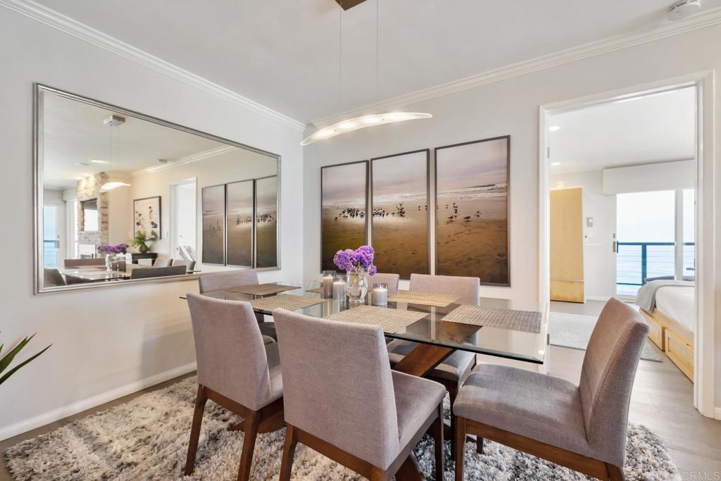 940 Sealane Drive, Unit 14 Encinitas, CA 92024 - Photo 12 of 45 a view of a dining room with furniture wooden floor and a chandelier