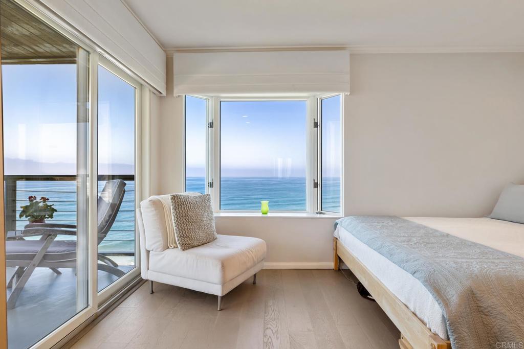 940 Sealane Drive, Unit 14 Encinitas, CA 92024 - Photo 15 of 45 a bedroom with a bed and large window