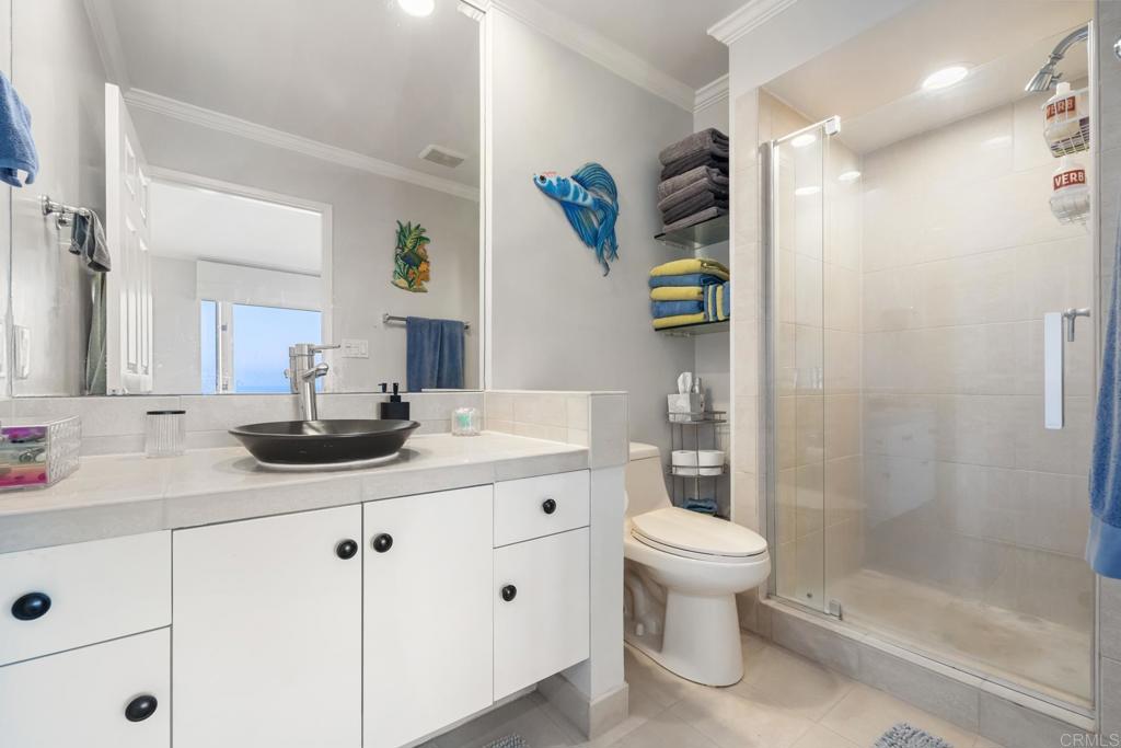 940 Sealane Drive, Unit 14 Encinitas, CA 92024 - Photo 19 of 45 a bathroom with a double vanity sink toilet and shower