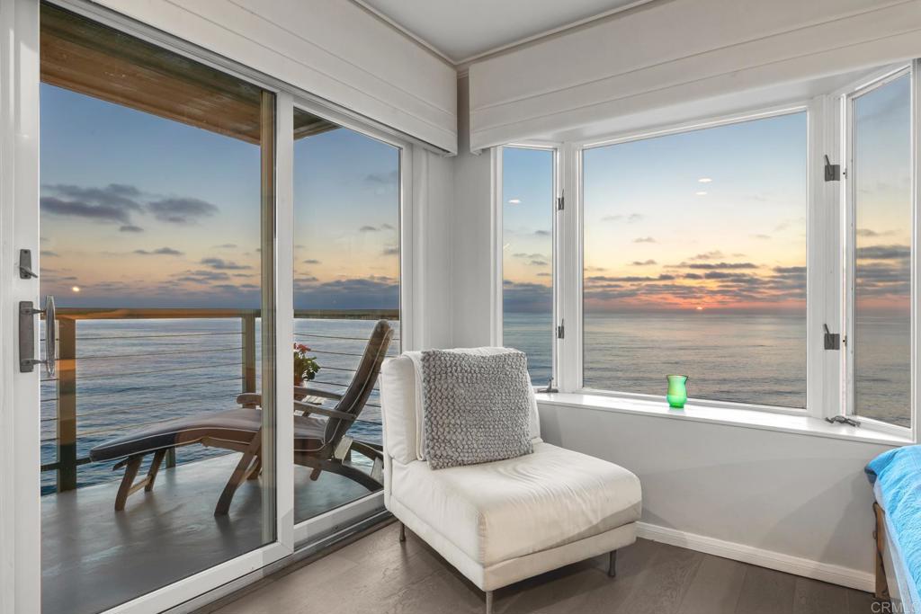 940 Sealane Drive, Unit 14 Encinitas, CA 92024 - Photo 34 of 45 a bedroom with a bed and a large window with balcony view