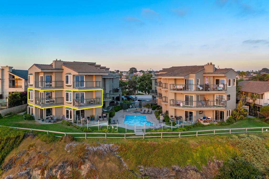 940 Sealane Drive, Unit 14 Encinitas, CA 92024 - Photo 42 of 45 a view of a large building with a big yard and large trees