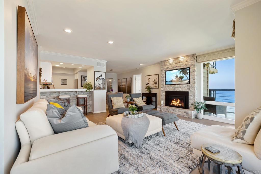 940 Sealane Drive, Unit 14 Encinitas, CA 92024 - Photo 5 of 45 a living room with furniture a fireplace and a flat screen tv
