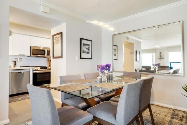 a dining room with furniture and wooden floor