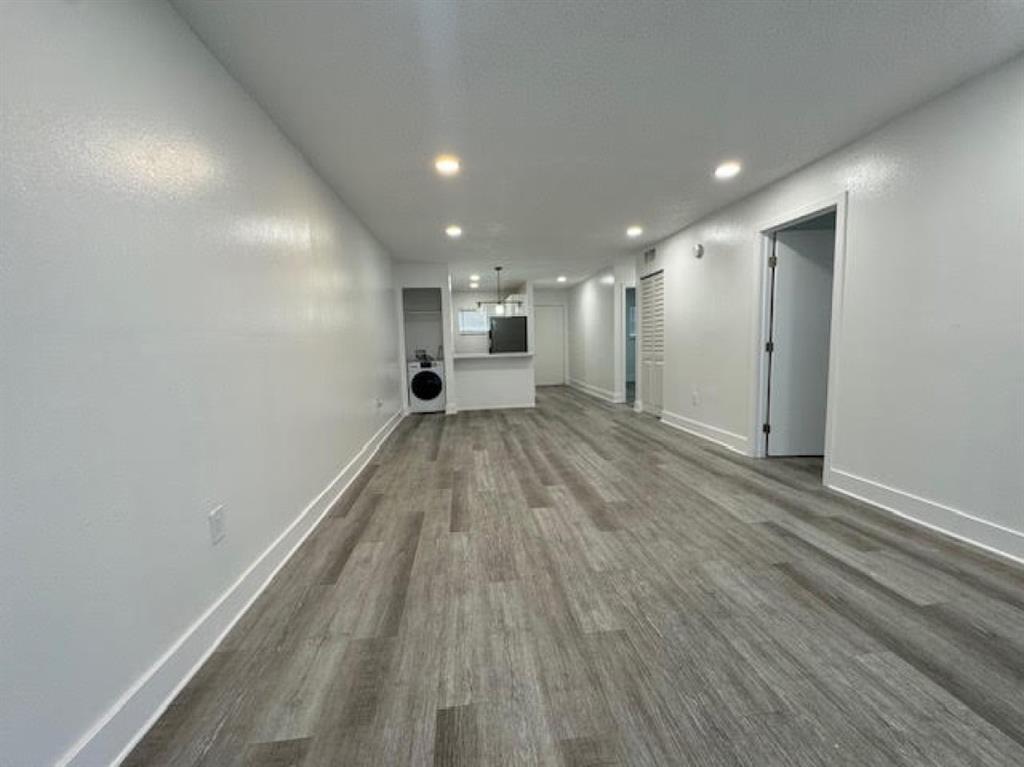 5525 Southwest 41st Street, Unit 306 Hollywood, FL 33023 - Photo 6 of 11 a view of a big room with wooden floor and a window