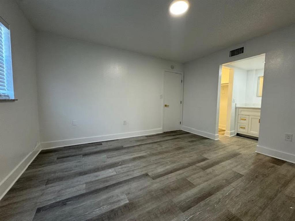 5525 Southwest 41st Street, Unit 306 Hollywood, FL 33023 - Photo 7 of 11 an empty room with wooden floor and windows