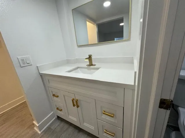 a bathroom with a sink vanity and mirror