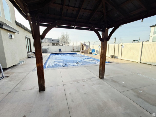 552 Sunset Crest Way Draper, UT 84020 - Photo 62 of 68 View of swimming pool with a water slide, a gazebo, a patio, and a fenced backyard