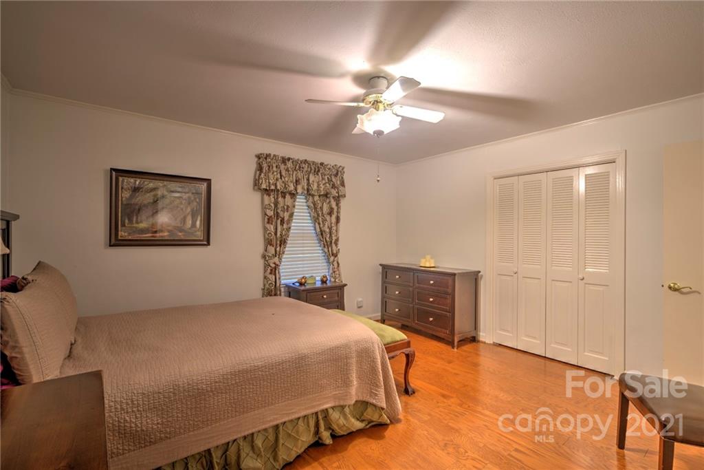 1127 Richmond Road, Unit 1 & 22 Rockingham, NC 28379 - Photo 25 of 41 a bedroom with a bed and a chandelier