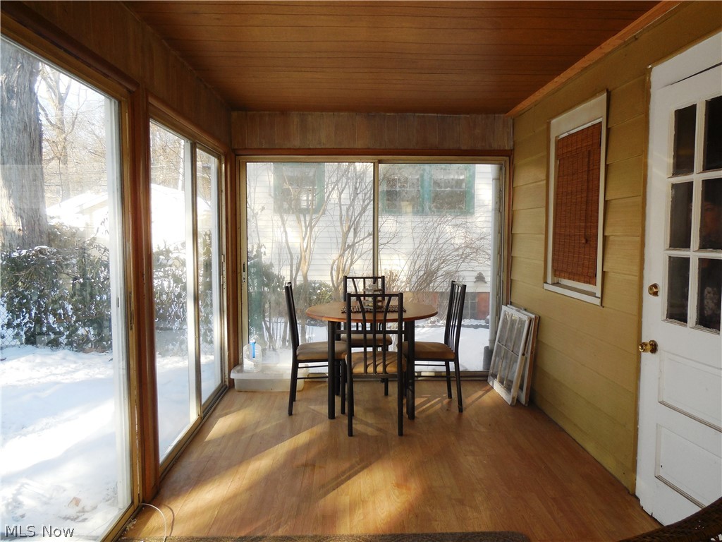 210 Linden Road Kent, OH 44240 - Photo 11 of 12 Enclosed back porch is a 3 seasons room with laminate flooring and sliding glass doors that lead out to the back yard.