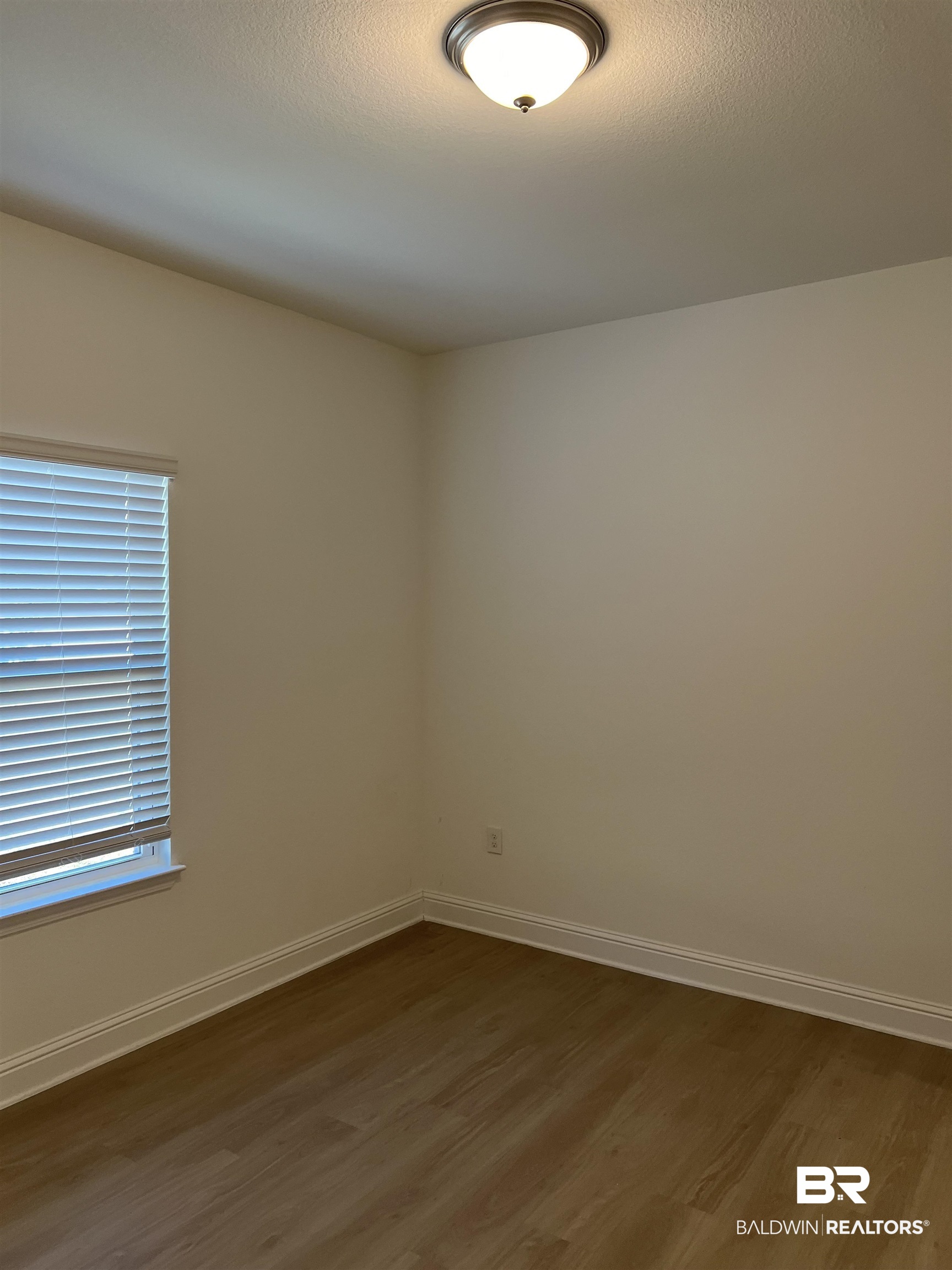 8855 Calverton Street Foley, AL 36535 - Photo 20 of 76 Empty room featuring dark hardwood / wood-style floors and a textured ceiling