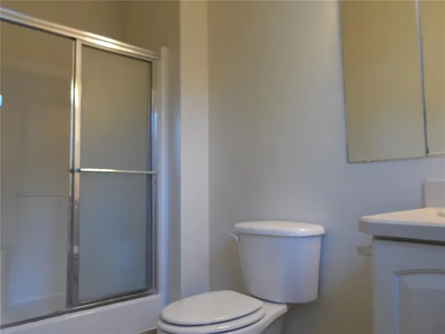 a white toilet sitting next to a bathroom sink