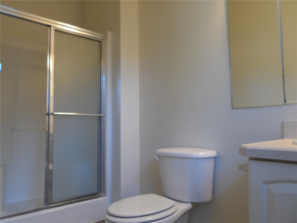 1221 Northwest 35th Avenue Gainesville, FL 32609 - Photo 12 of 16 a white toilet sitting next to a bathroom sink