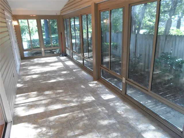 a view of backyard with wooden floor and fence