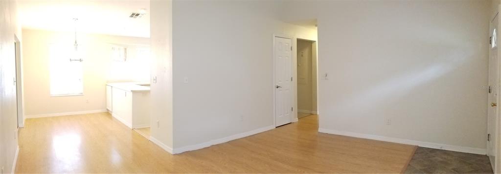1221 Northwest 35th Avenue Gainesville, FL 32609 - Photo 3 of 16 a view of a hallway with wooden floor