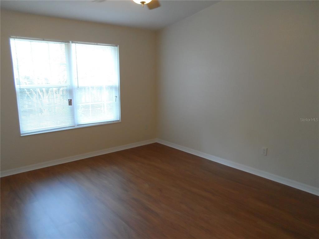 1221 Northwest 35th Avenue Gainesville, FL 32609 - Photo 10 of 16 an empty room with wooden floor and windows
