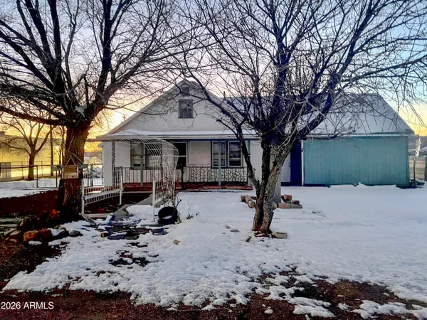 a view of a house with wooden deck front of house