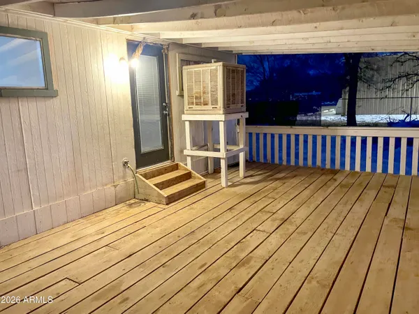 a view of a small space with wooden floor and a window