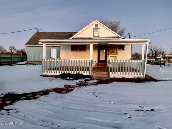 a view of a house with wooden fence