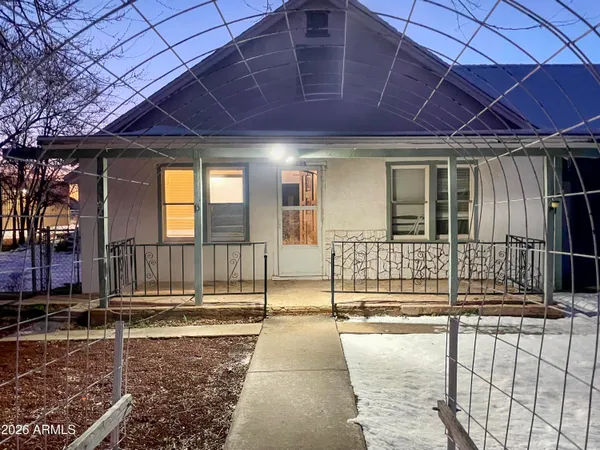 a view of an empty room with wooden floor and closet