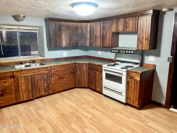 a kitchen with stainless steel appliances granite countertop wooden cabinets a sink and dishwasher
