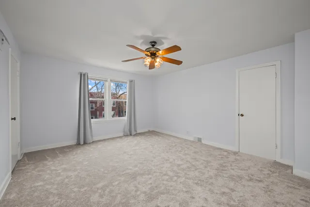 a view of empty room with a fan