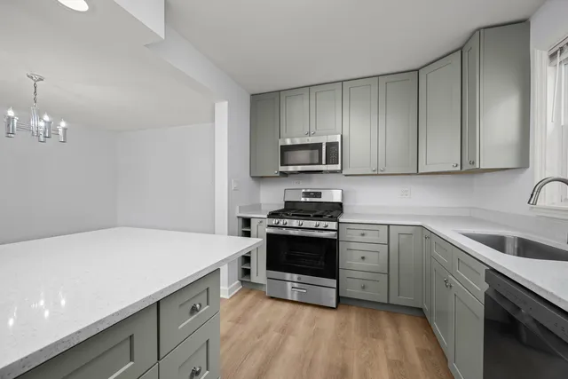 a kitchen with a sink a stove and cabinets