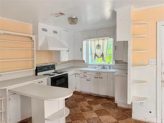 a kitchen with a sink a stove a refrigerator and a stove