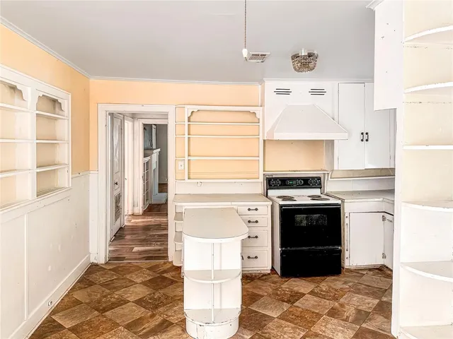 a kitchen with stainless steel appliances granite countertop a refrigerator and a stove