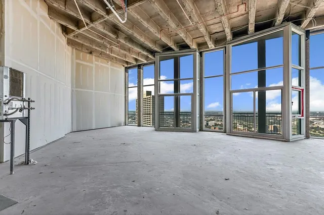 a view of an empty room with windows