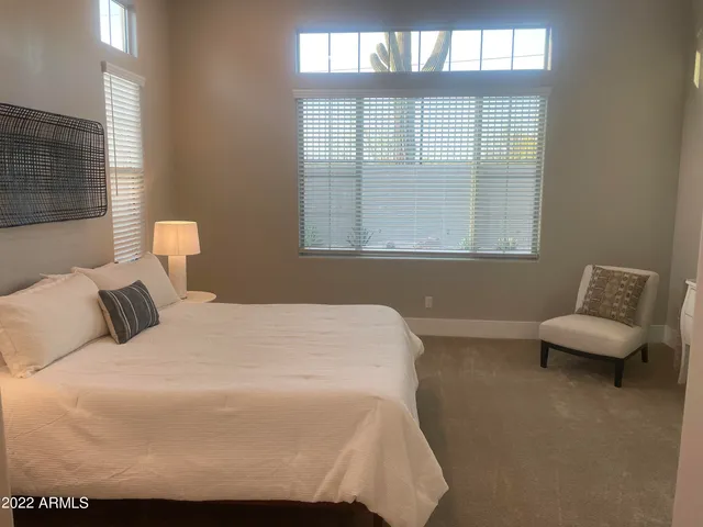 a bedroom with bed and flat screen tv
