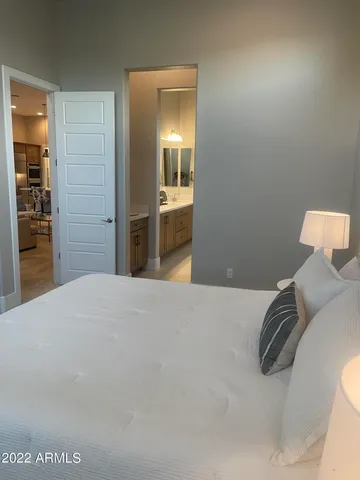 a bedroom with a bed a lamp and a window