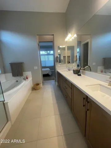 a bathroom with a sink double vanity granite and a mirror