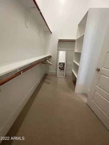 a bathroom with a tub a sink and a large mirror